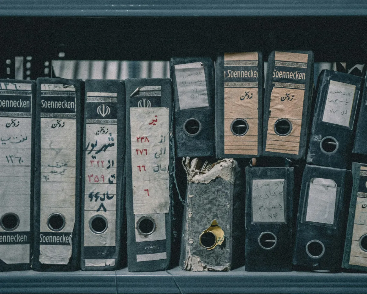 Shelves of worn binders in an archive