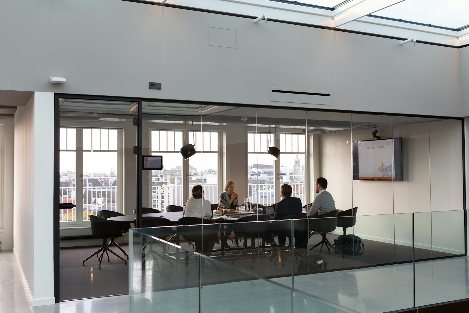 A kick-off meeting in a glass conference room