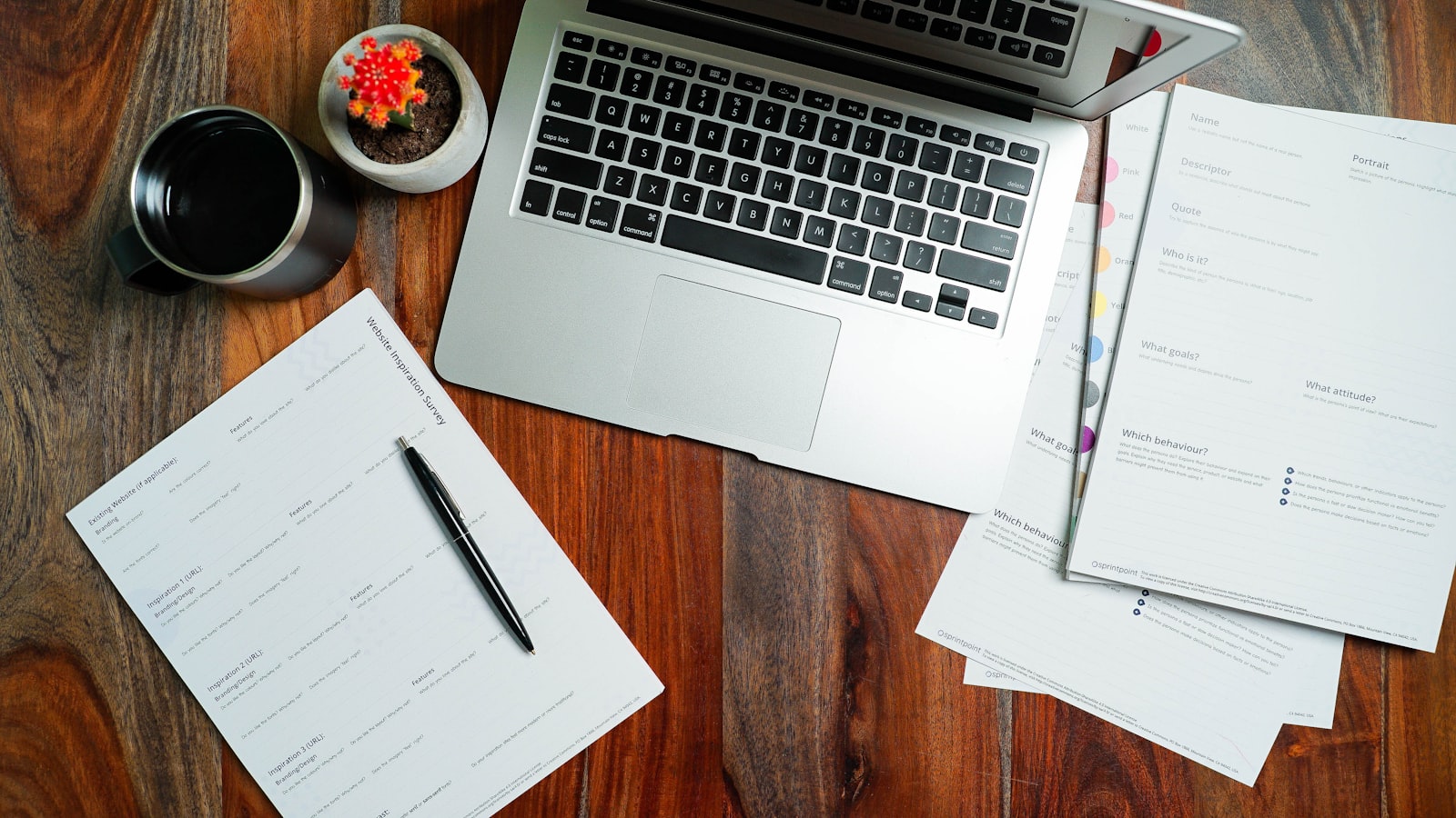 A laptop and paper records on a desk